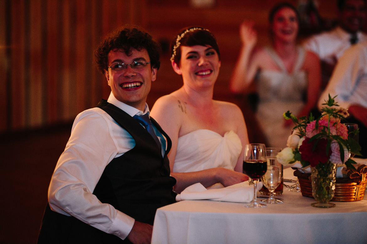 Bride and Groom laughing during toasts at wedding reception at Fireseed Catering on Whidbey Island, WA