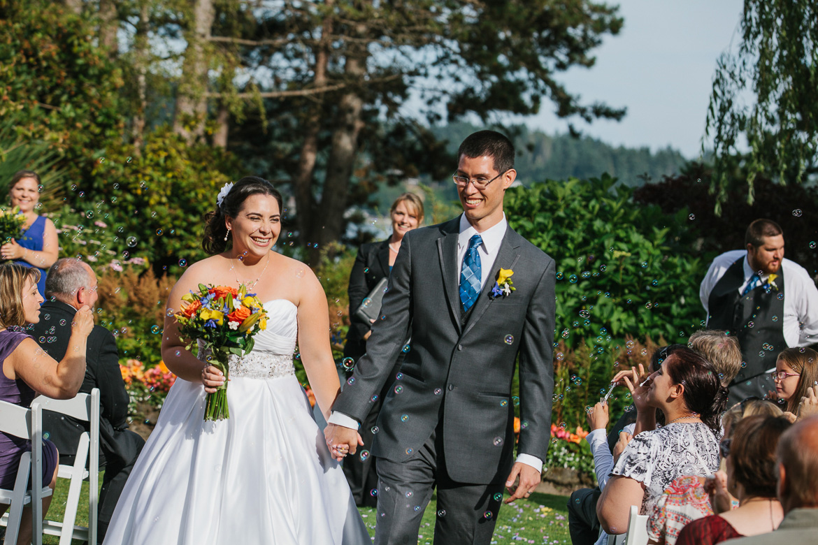 Bride and groom walking down aisle during wedding ceremony at Kiana Lodge in Poulsbo, WA