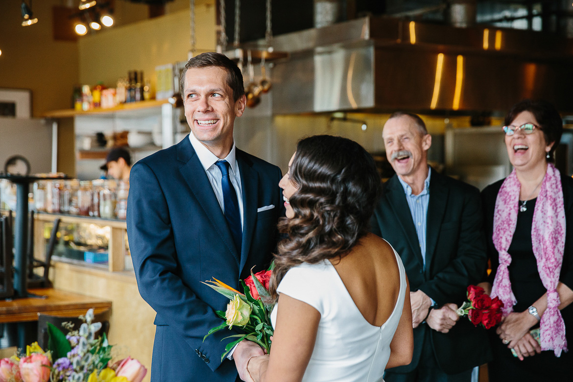 Groom and parents laughing during Pike Place Market elopement in Seattle, WA