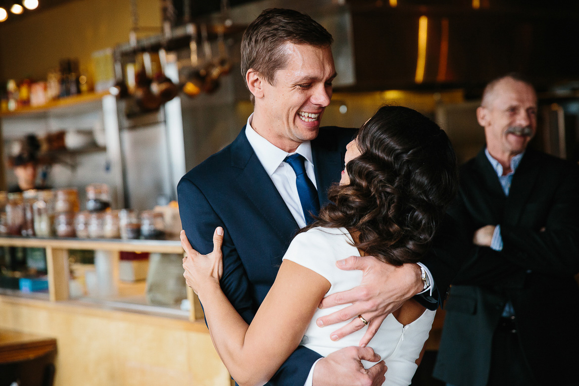 Groom laughing after first kiss with bride during a Seattle elopement