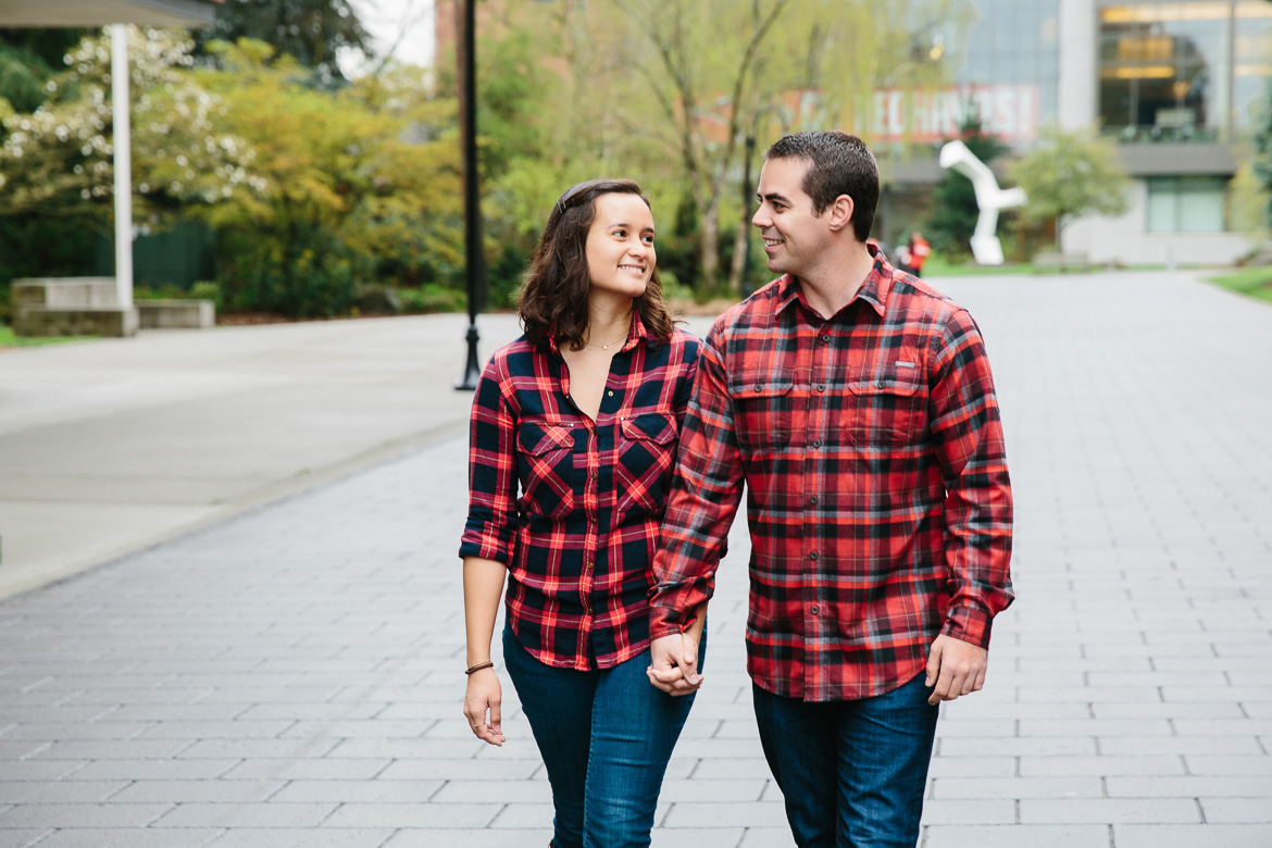 Couple walking during engagement photos at Seattle University in Washington