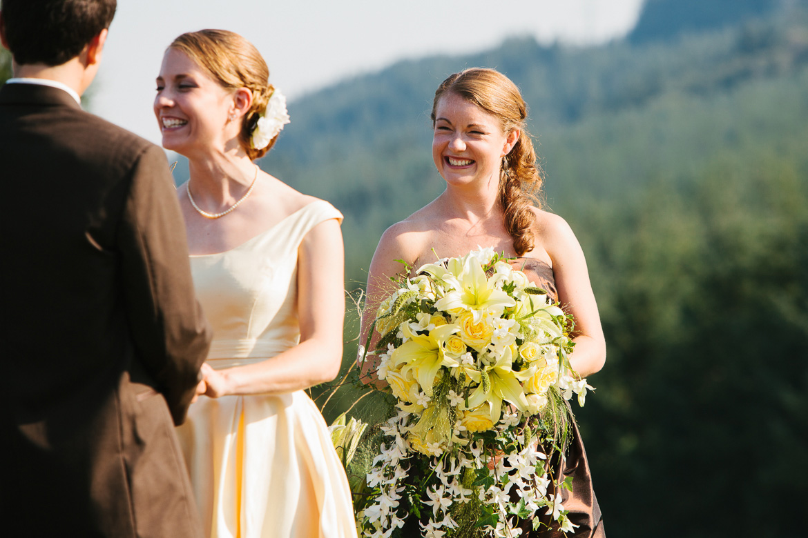 Bridesmaid laughing during wedding ceremony at Snoqualmie Point Park with Cascade Mt views