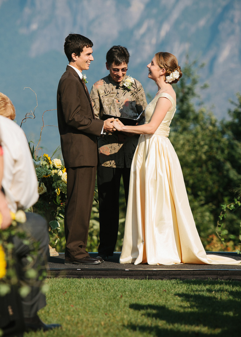 Bride adn groom during wedding ceremony at Snoqualmie Point Park with Cascade Mt views