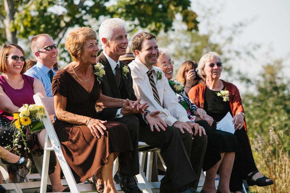 Bride's parents laughing during wedding ceremony at Snoqualmie Point Park with Cascade Mt views