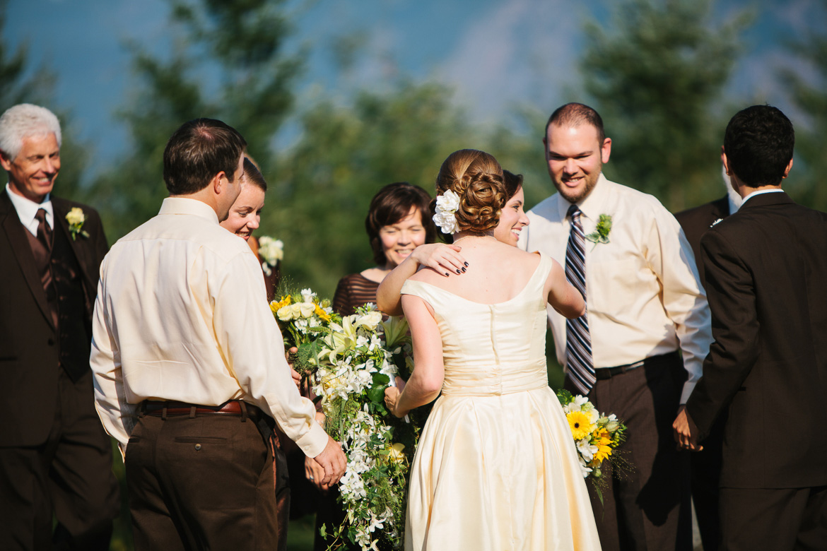 Bride and groom during recieving line after wedding ceremony at Snoqualmie Point Park with Cascade Mountain views