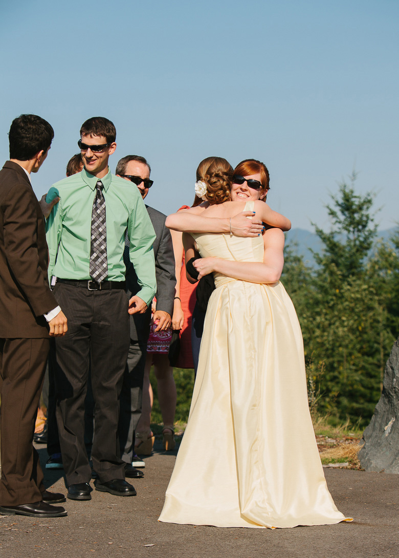 Bride and groom during recieving line after wedding ceremony at Snoqualmie Point Park with Cascade Mountain views