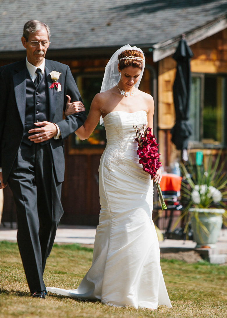Bride walking down aisle for wedding ceremony at Whidbey Island Winery in Washington
