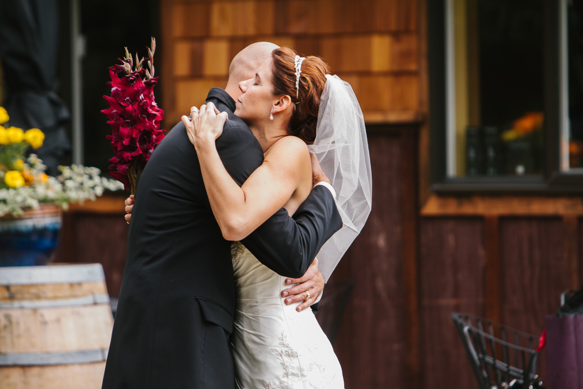 Bride and groom hugging after wedding ceremony at Whidbey Island Winery in Washington