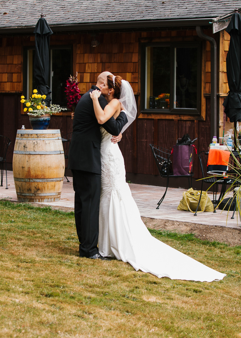 Bride and groom hugging after wedding ceremony at Whidbey Island Winery in Washington