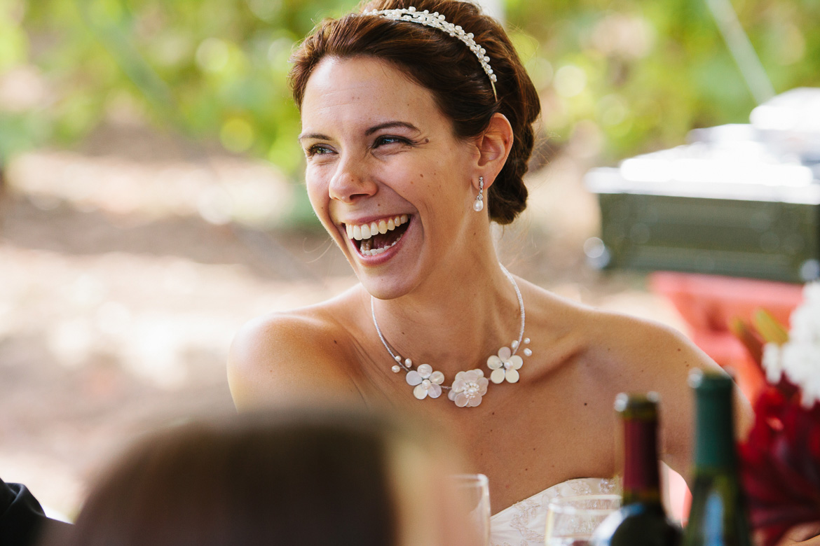 Bride laughing during wedding toasts at Whidbey Island Winery in Washington