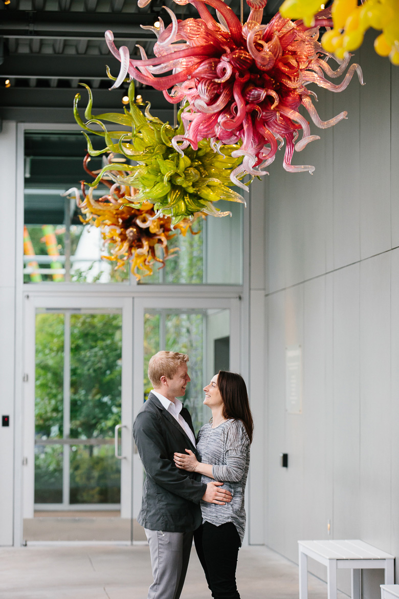Couple smiling at Chihuly Garden and Glass engagement session in Seattle, WA