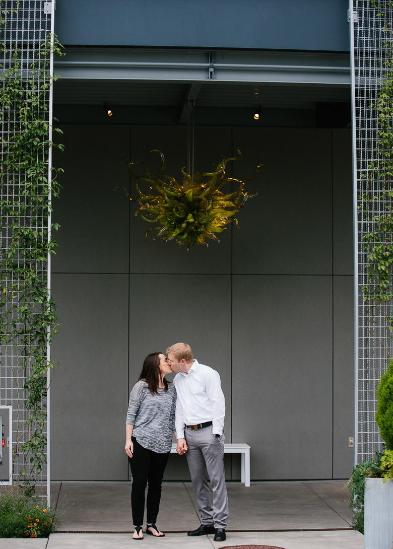 Couple kissing at Chihuly Garden and Glass engagement session in Seattle, WA