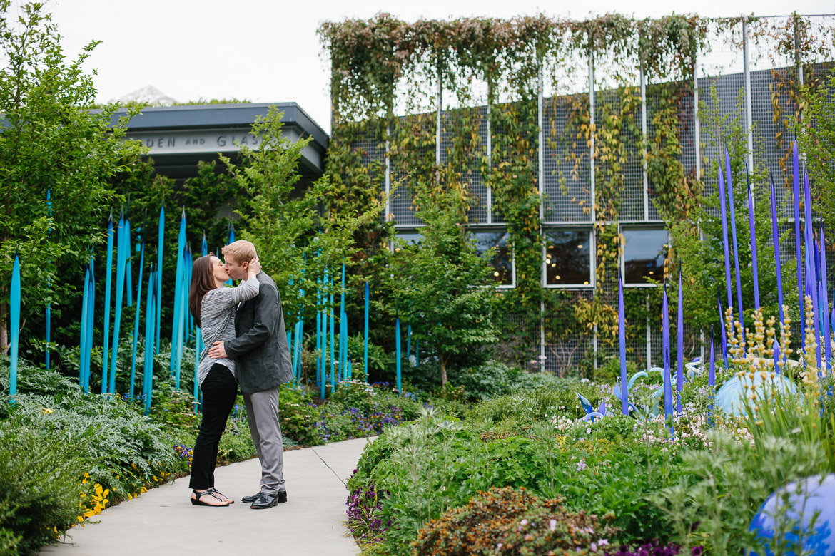 Couple kissing at Chihuly Garden and Glass engagement session in Seattle, WA