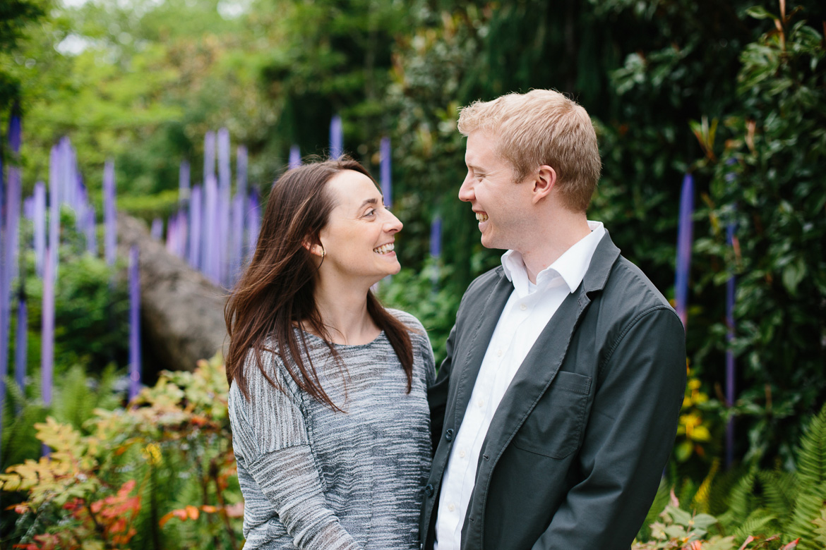 Couple laughing at Chihuly Garden and Glass engagement session in Seattle, WA