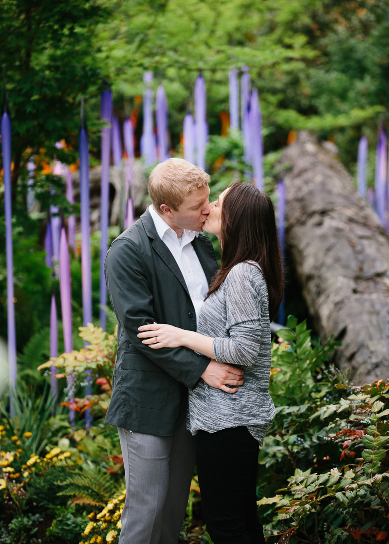 Couple kissing at Chihuly Garden and Glass during engagement photos in Seattle, WA