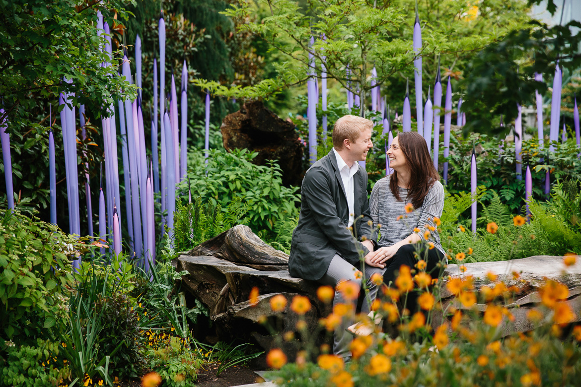 Couple laughing at Chihuly Garden and Glass during engagement photos in Seattle, WA