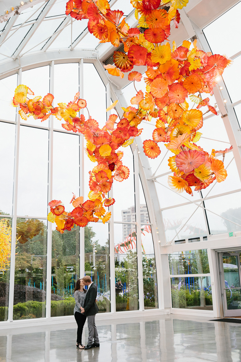 Couple during engagement photos at Chihuly Garden and Glass in Seattle, WA