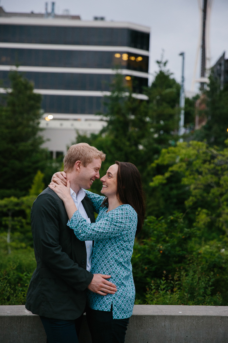 Couple laughing at Olympic Sculpture Park during engagement photos in Seattle, WA
