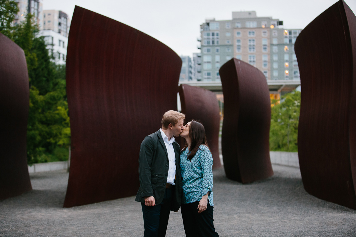 Couple kissing during engagement photos in Olympic Sculpture Park in Seattle, WA
