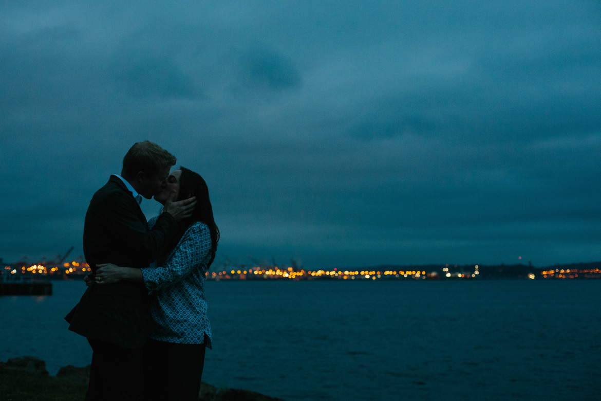 Couple kissing during engagement photos in Myrtle Edwards Park in Seattle, WA