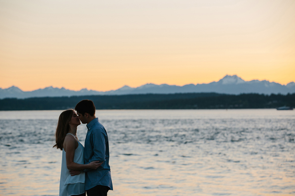 Couple almost kissing during sunset engagement photos at Discovery Park in Seattle, Washington