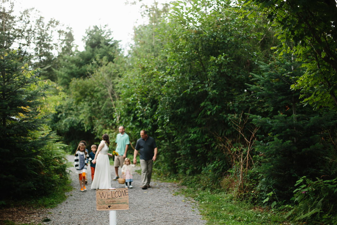 Bride and bridal party walking to wedding ceremony at Wallace Falls State Park in Gold Bar, WA
