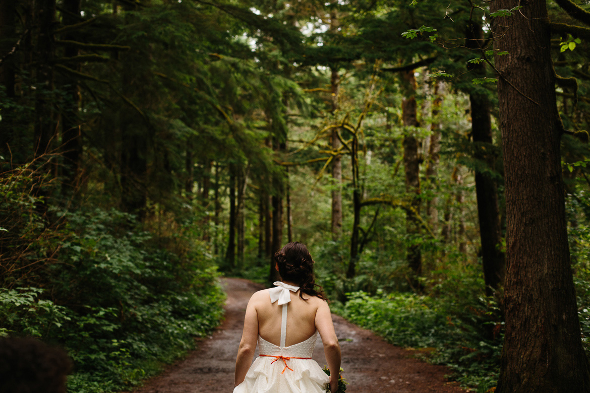 Bride walking to wedding ceremony at Wallace Falls State Park in Gold Bar, WA