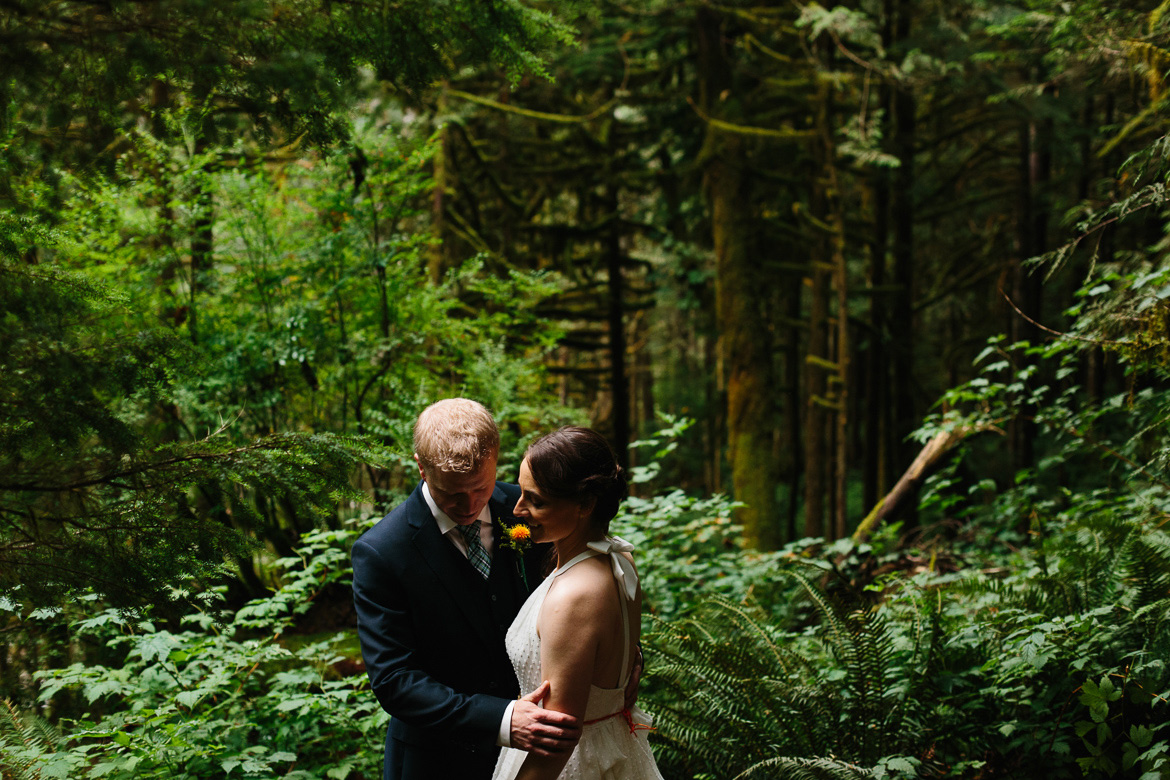 Bride and groom smiling during forest wedding portraits at Wallace Falls State Park in Gold Bar, WA