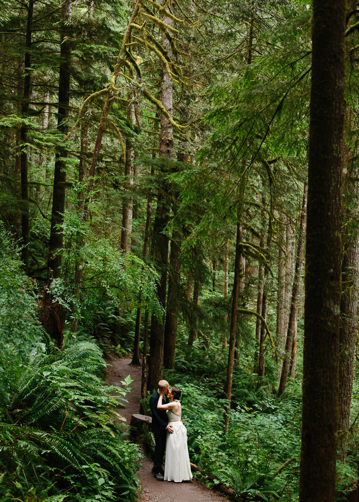 Bride and Groom kissing during forest wedding portraits in Wallace Falls State Park in Gold Bar, WA