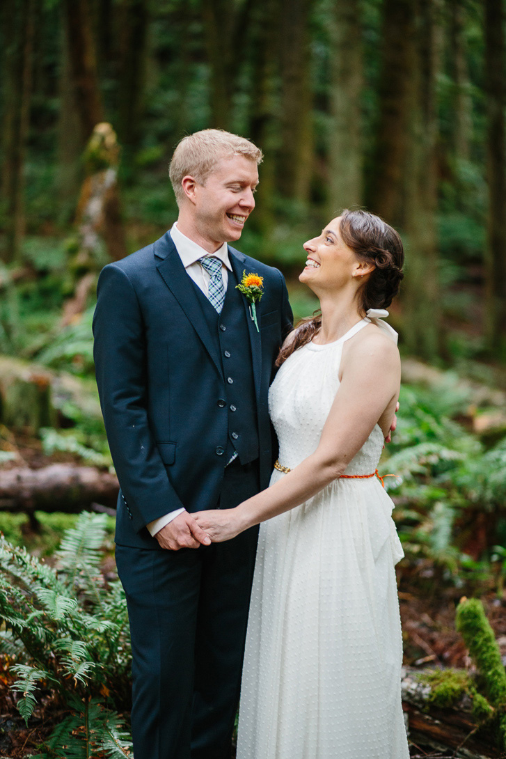 Bride and groom smiling during forest wedding portraits at Wallace Falls State Park in Gold Bar, WA