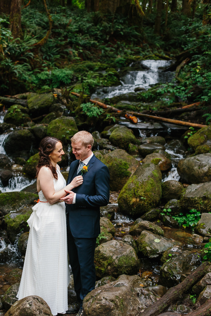 Bride and groom smiling during waterfall wedding portraits at Wallace Falls State Park in Gold Bar, WA