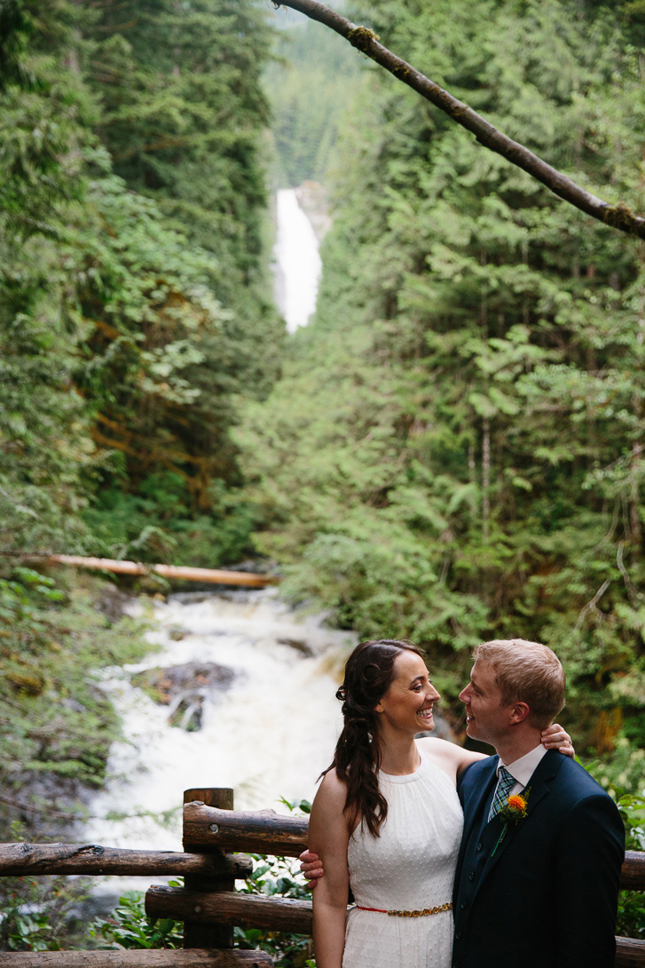 Bride and groom kissing in front of outlook during wedding portraits at Wallace Falls State Park in Gold Bar, WA
