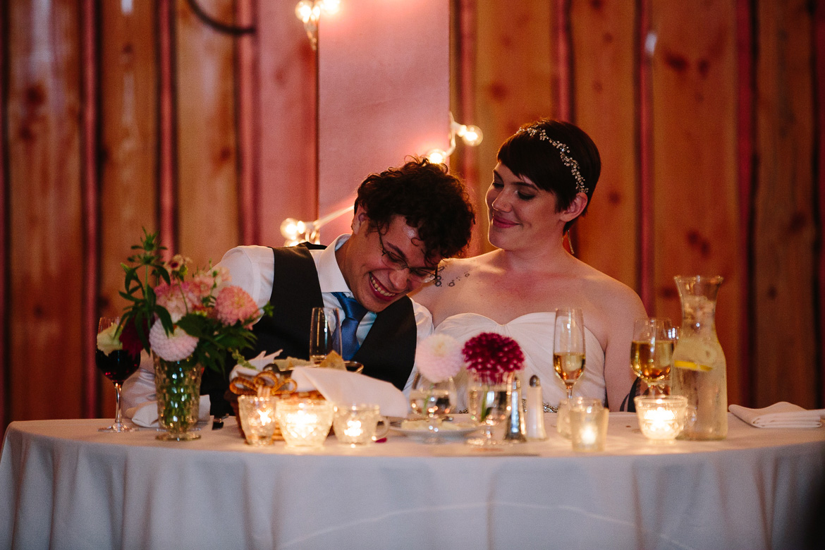 Bride and groom laughing during toast during wedding at Fireseed Catering on Whidbey Island, WA