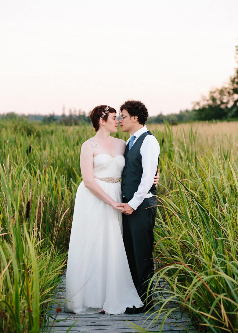 Bride and groom in field during sunset at Fireseed Catering wedding on Whidbey Island, WA