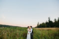 Bride and groom kissing in field during sunset at Fireseed Catering wedding on Whidbey Island, WA
