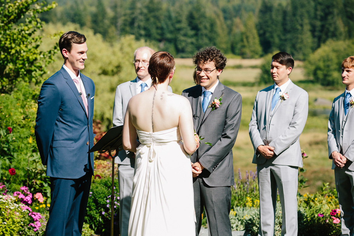 Groom smiling during wedding ceremony at Fireseed Catering on Whidbey Island, WA