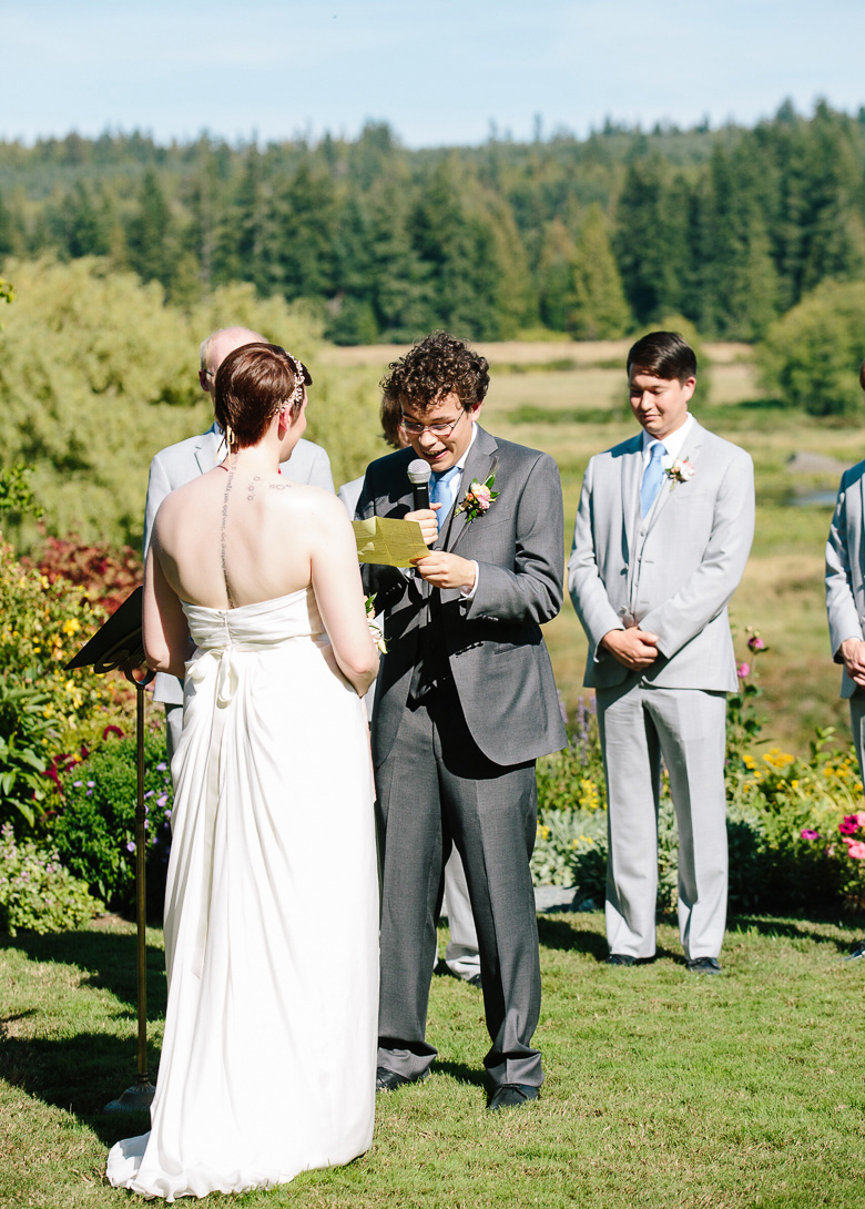 Groom saying vows during wedding ceremony at Fireseed Catering on Whidbey Island, WA