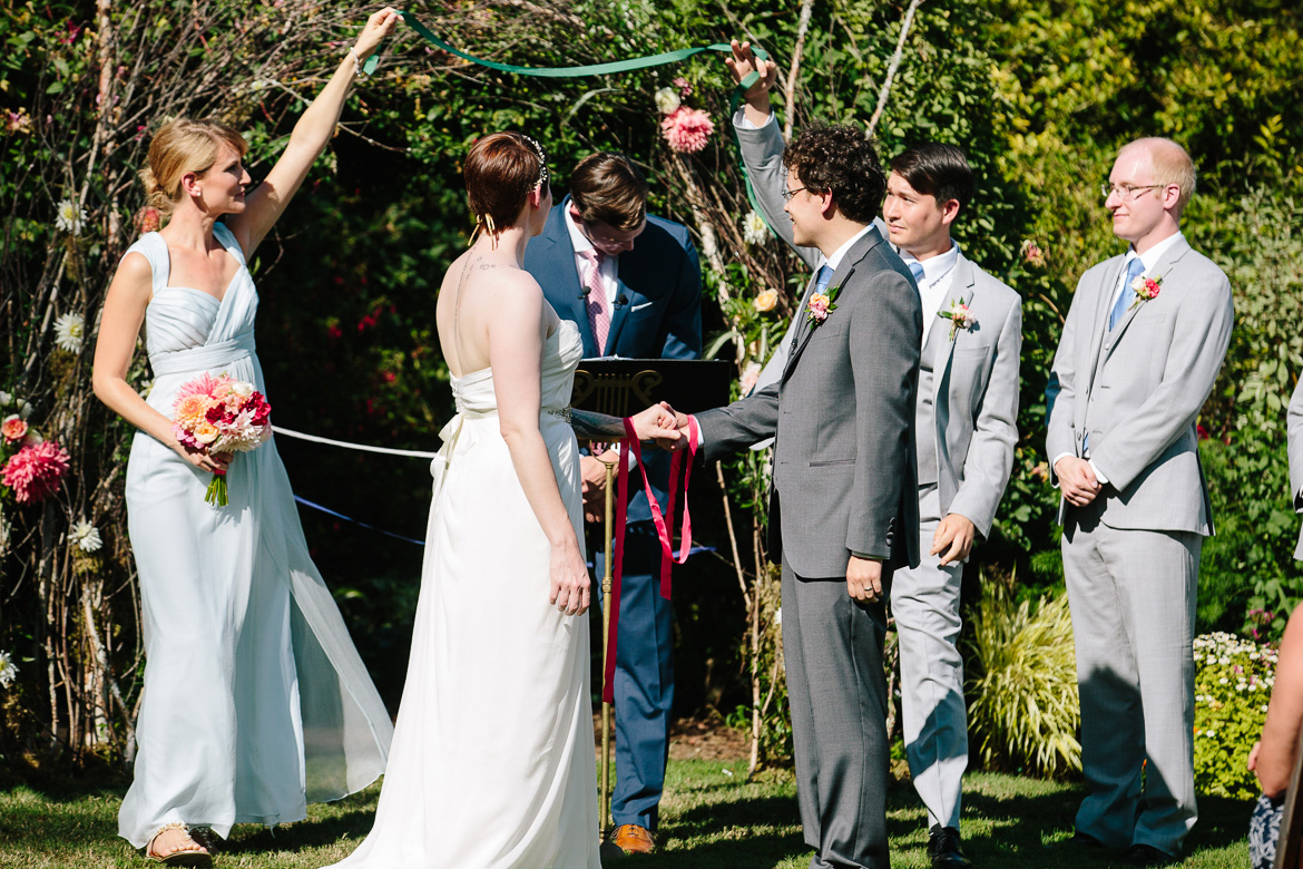 Bridal party during ribbon ceremony during wedding ceremony at Fireseed Catering on Whidbey Island, WA