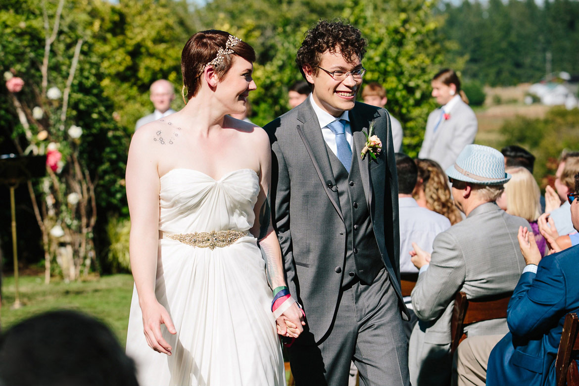 Bride and groom walking down aisle after wedding ceremony at Fireseed Catering on Whidbey Island, WA