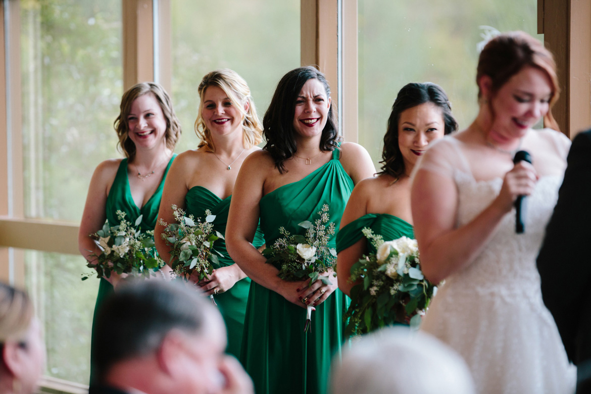 Bridesmaids laughing during wedding ceremony at Lake Wilderness Lodge in Maple Valley, WA
