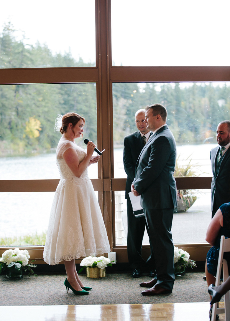Bride giving vows during wedding ceremony at Lake Wilderness Lodge in Maple Valley, WA