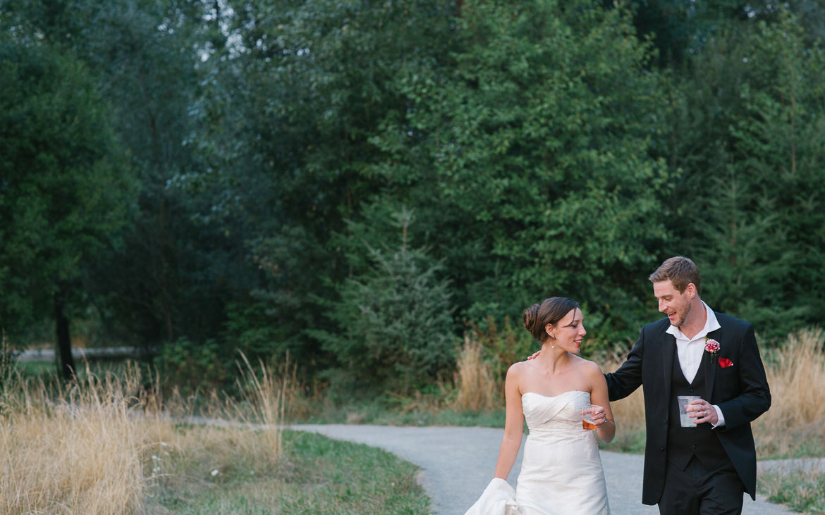 Bride and groom walking during sunset portraits at Center for Urban Horticulture in Seattle, WA