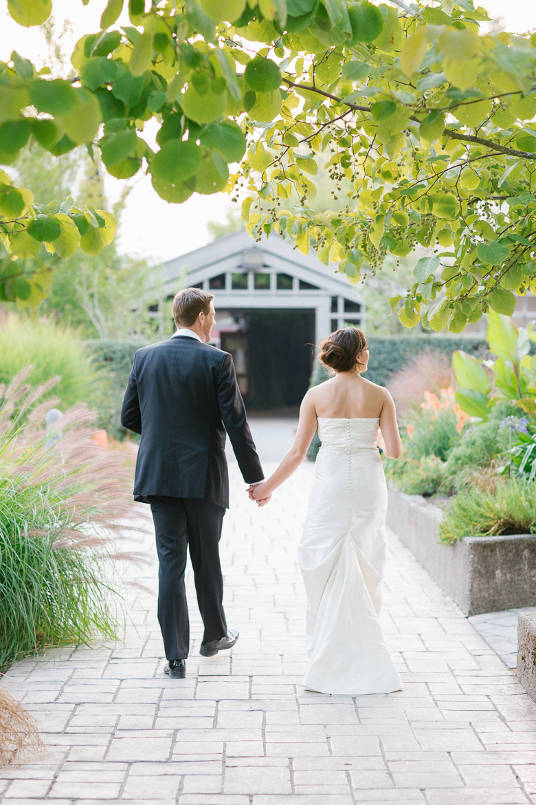 Bride and groom walking during sunset portraits at Center for Urban Horticulture in Seattle, WA