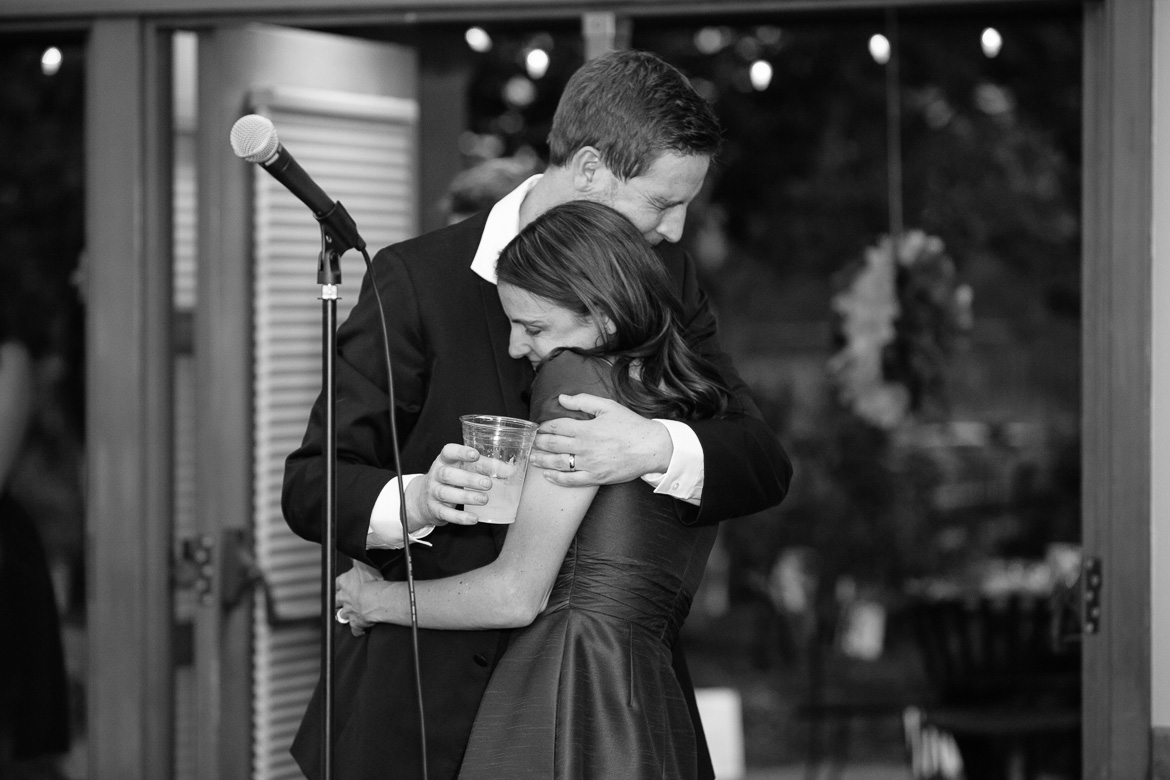 Groom hugging sister during toasts at wedding reception at Center for Urban Horticulture in Seattle, WA