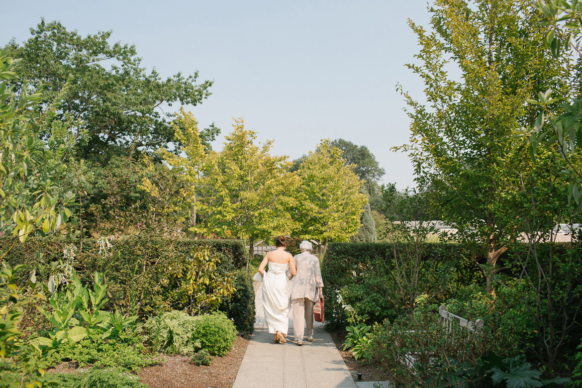 Bride walking with grandmother before wedding at Seattle Center for Urban Horticulture