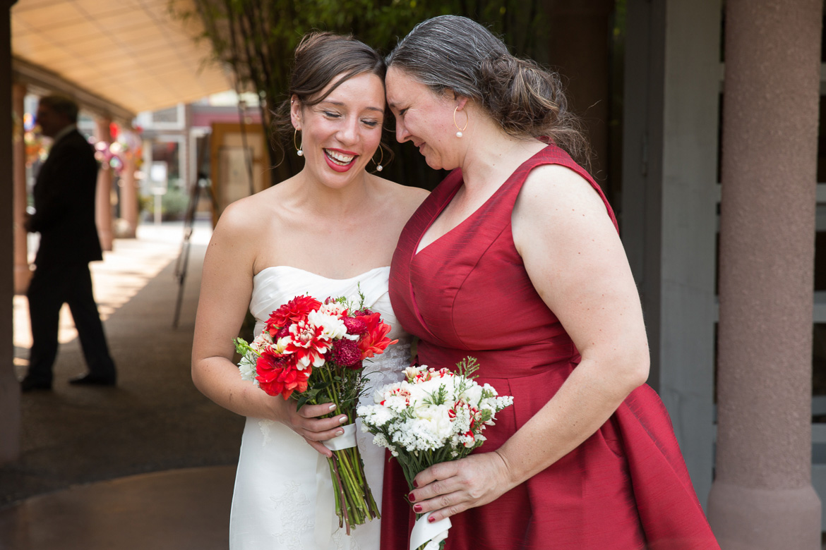 Bride and bridesmaid before wedding at Seattle Center for Urban Horticulture in Washington