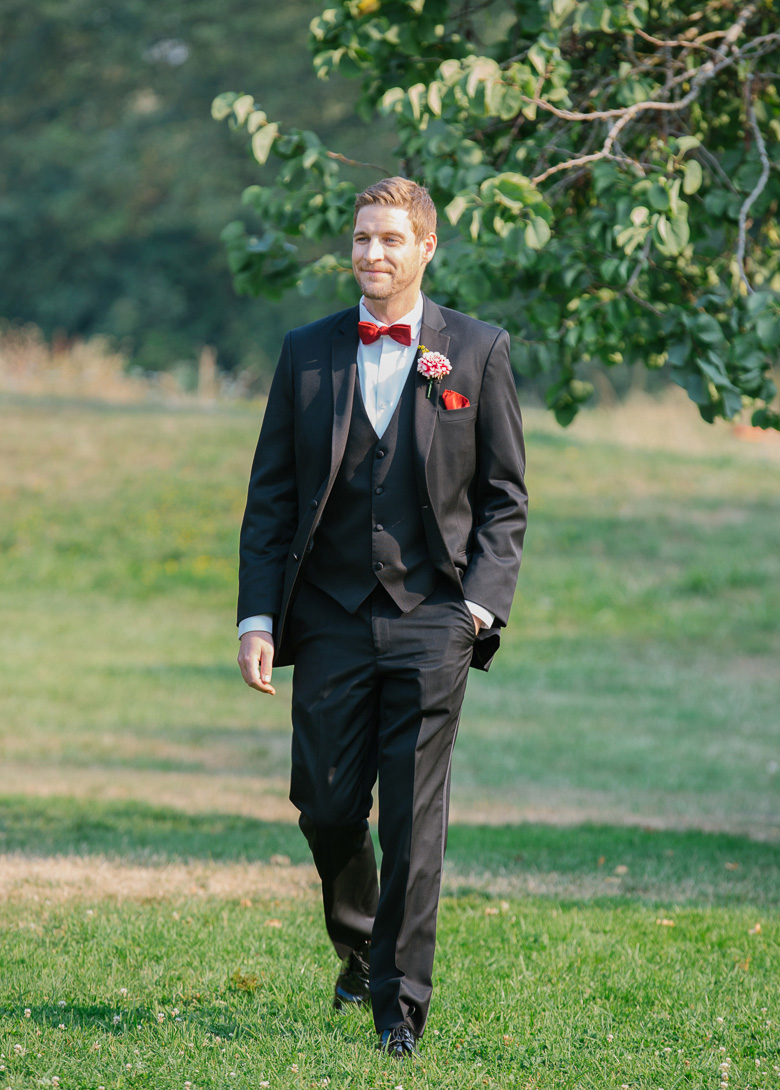Groom walking down aisle during wedding ceremony at Center for Urban Horticulture in Seattle, WA