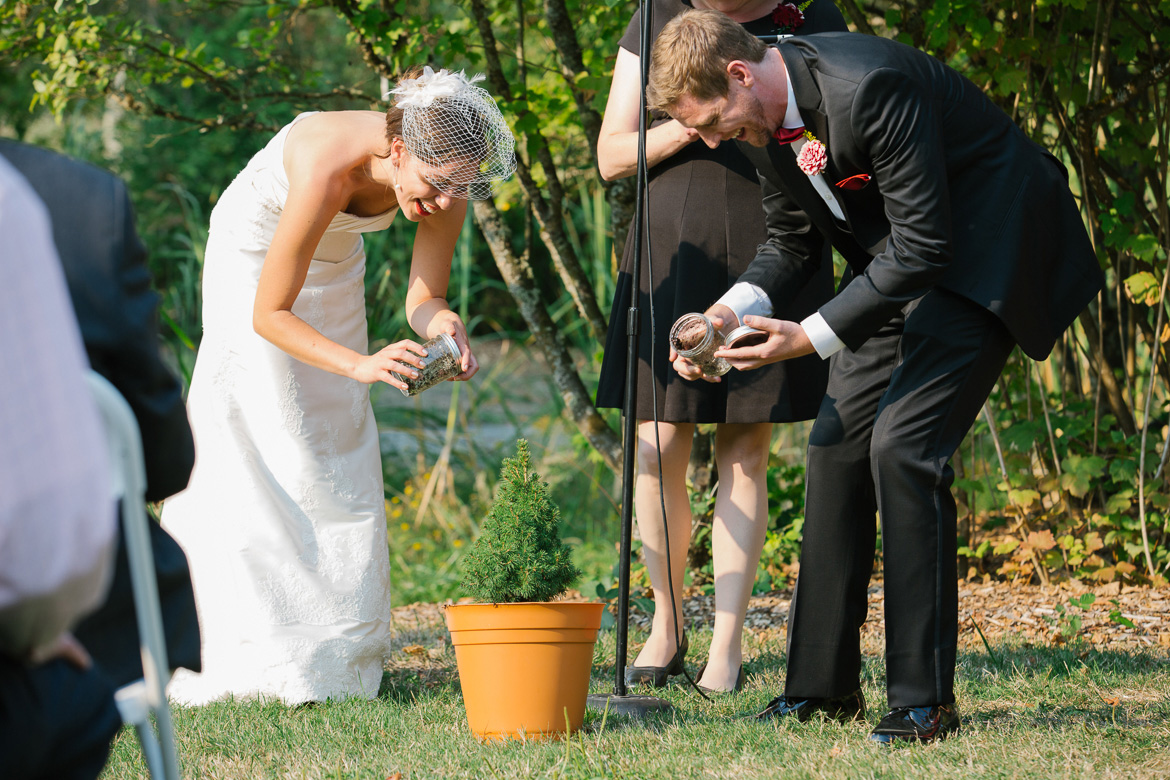 Bride and groom planting tree during wedding ceremony at Center for Urban Horticulture in Seattle, WA