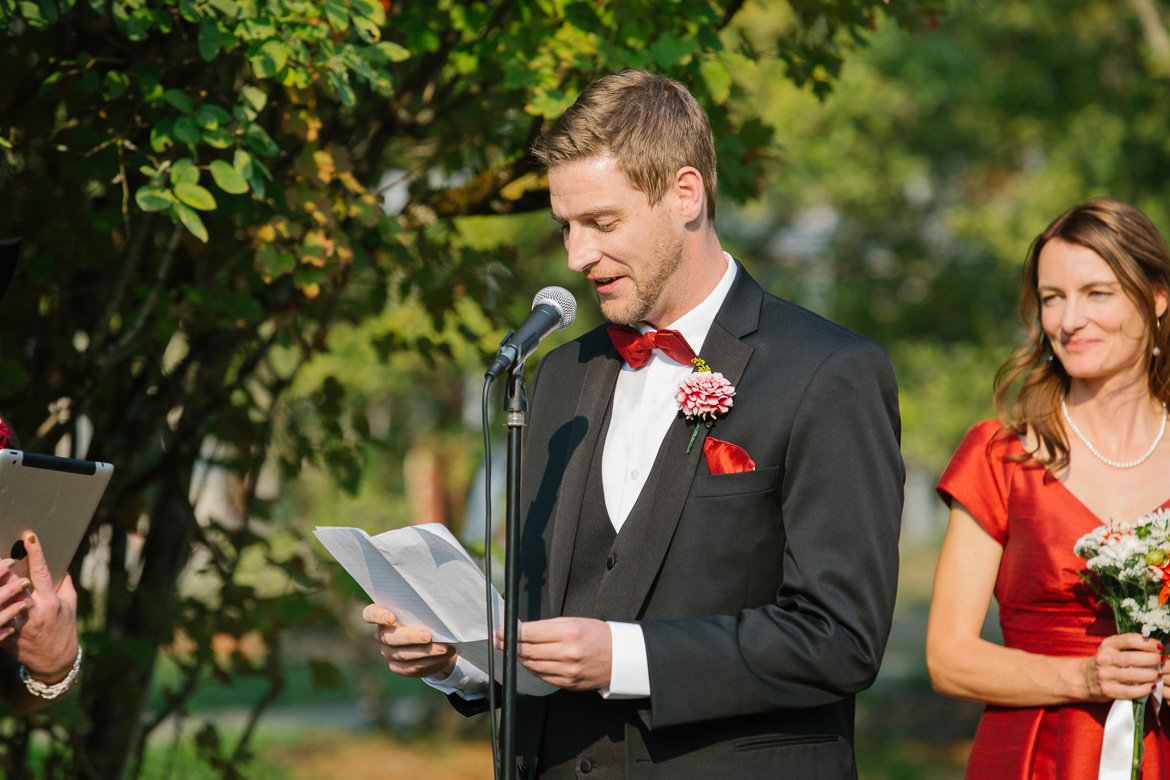 Groom reading vows during wedding ceremony at Seattle Center for Urban Horticulture