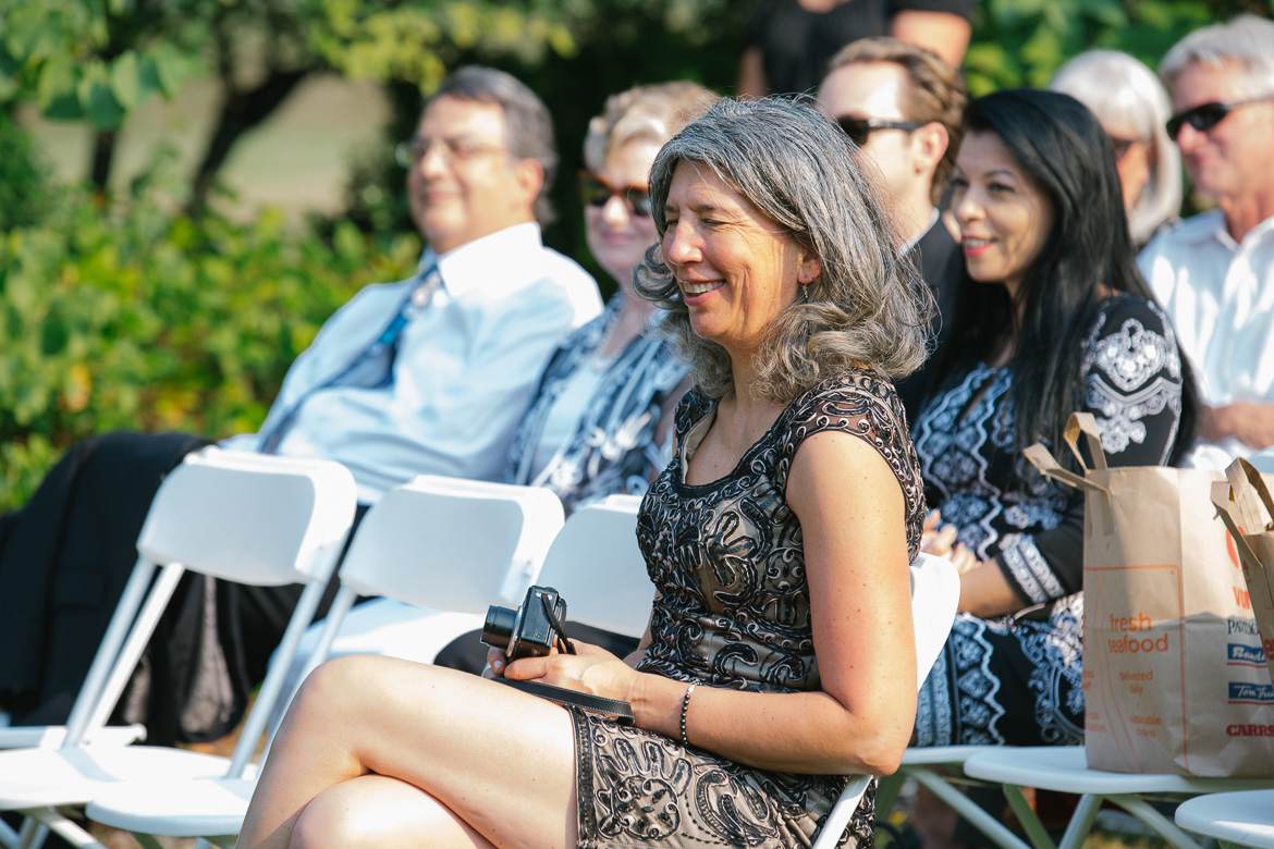 Mother of the bride laughing during wedding ceremony at Center for Urban Horticulture in Seattle, WA